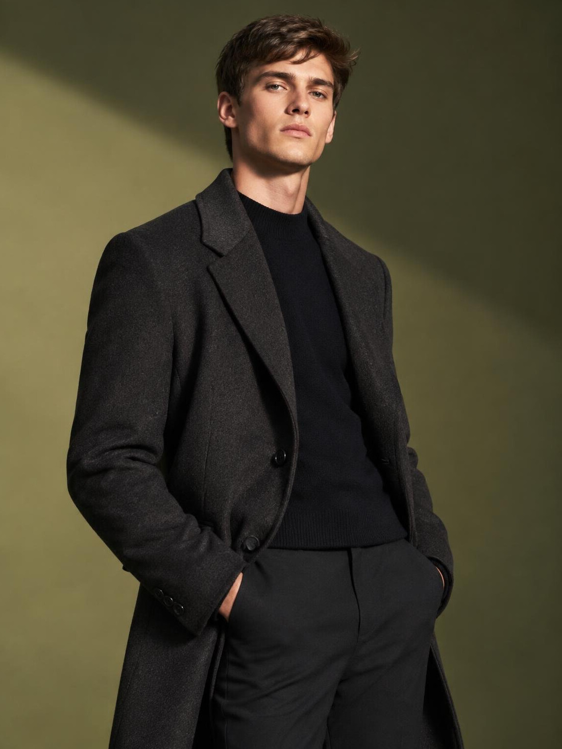 Editorial style portrait of a male model in a styled studio outfit